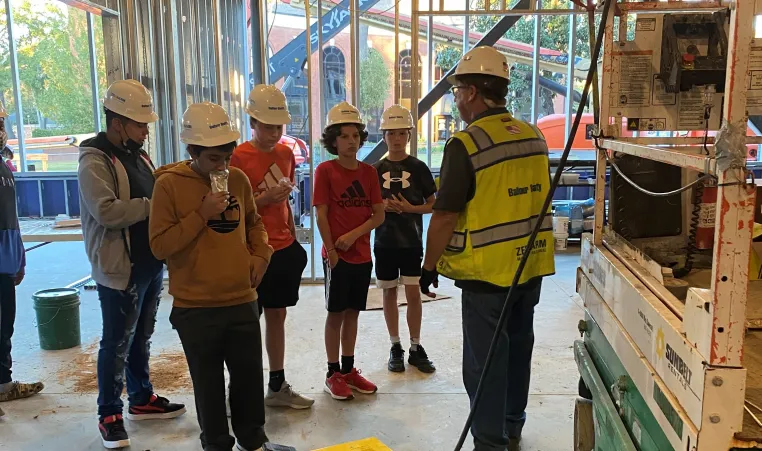 wilson middle schoolers at the site of the new Foundation YMCA during Construction Academy Program