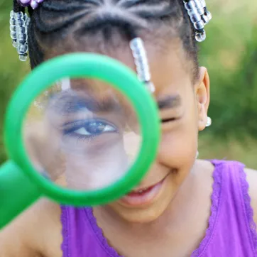 girl camper with magnifying glass