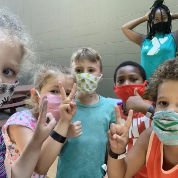 children together wearing masks at the Y