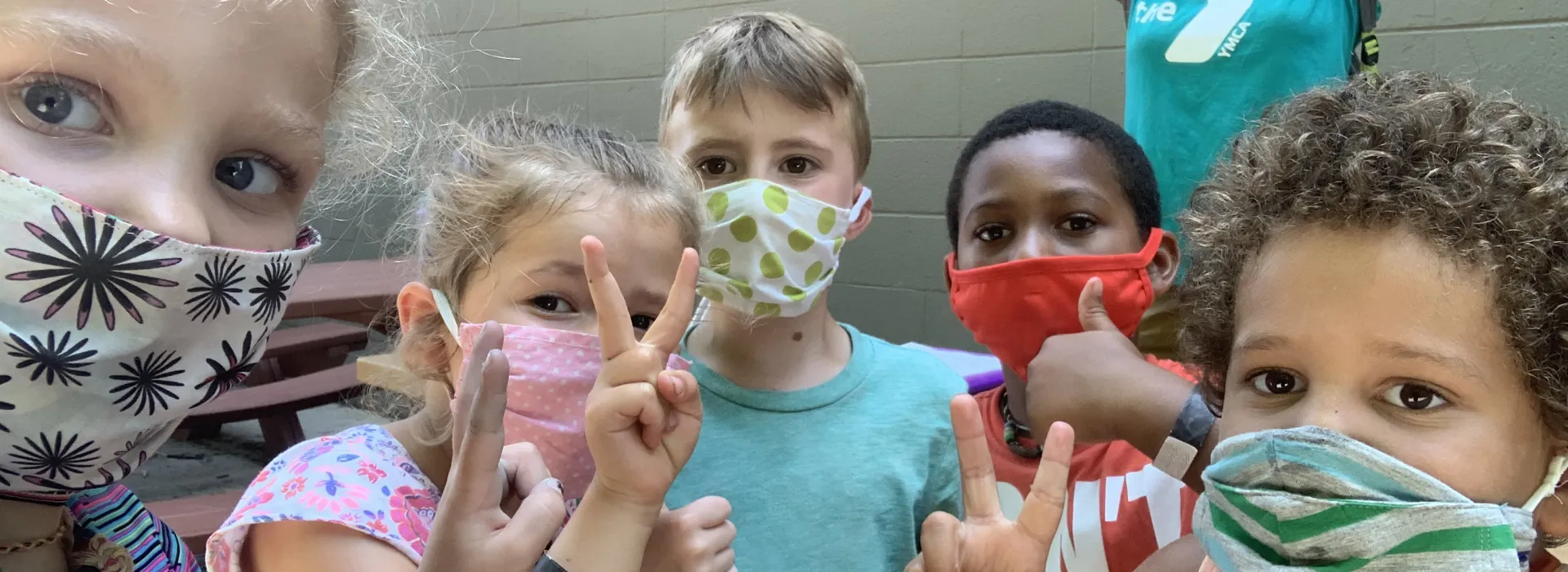 children together wearing masks at the Y