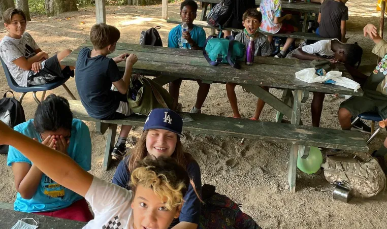 kids at picnic tables at summer camp